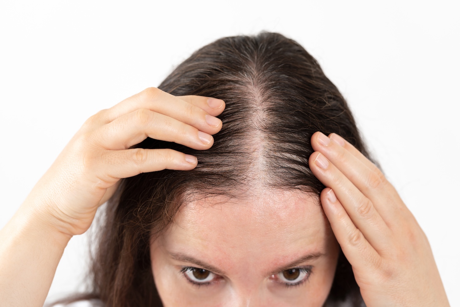 Close-up of woman checking hair loss